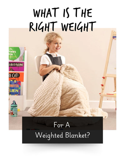young girl at on a chair with a weighted blanket over her lap
