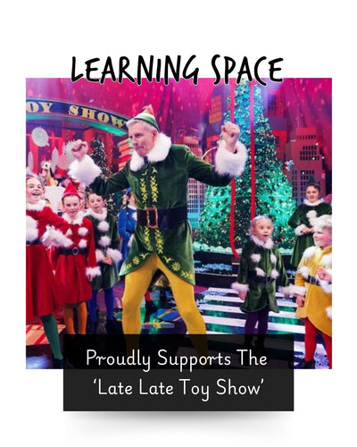 the late late toy show host dressed as an elf with children behind him dressed as elves and Santa for a Christmas toy tv show