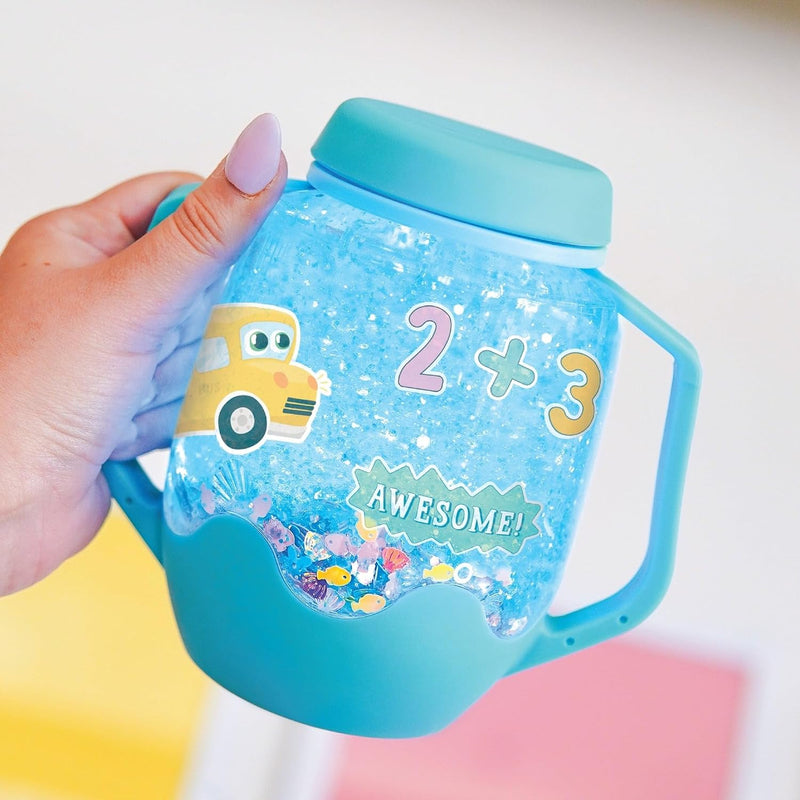 Close-up of a blue Glo Pals sensory jar with colourful fillers, number stickers and a yellow school bus.