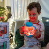 Child holding the blue Glo Pals ABC sensory jar by both handles as it glows orange