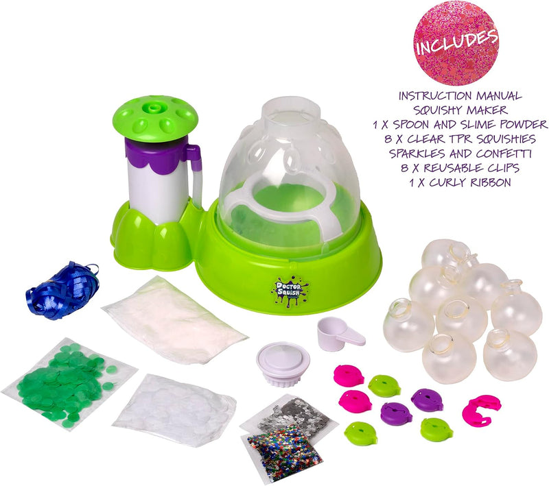 Squishy Maker slime kit with lime green and purple plastic machine, clear domes, colorful slime powders, clear TPK slime balls, curly ribbons, sparkles, and an instruction manual on a white background.