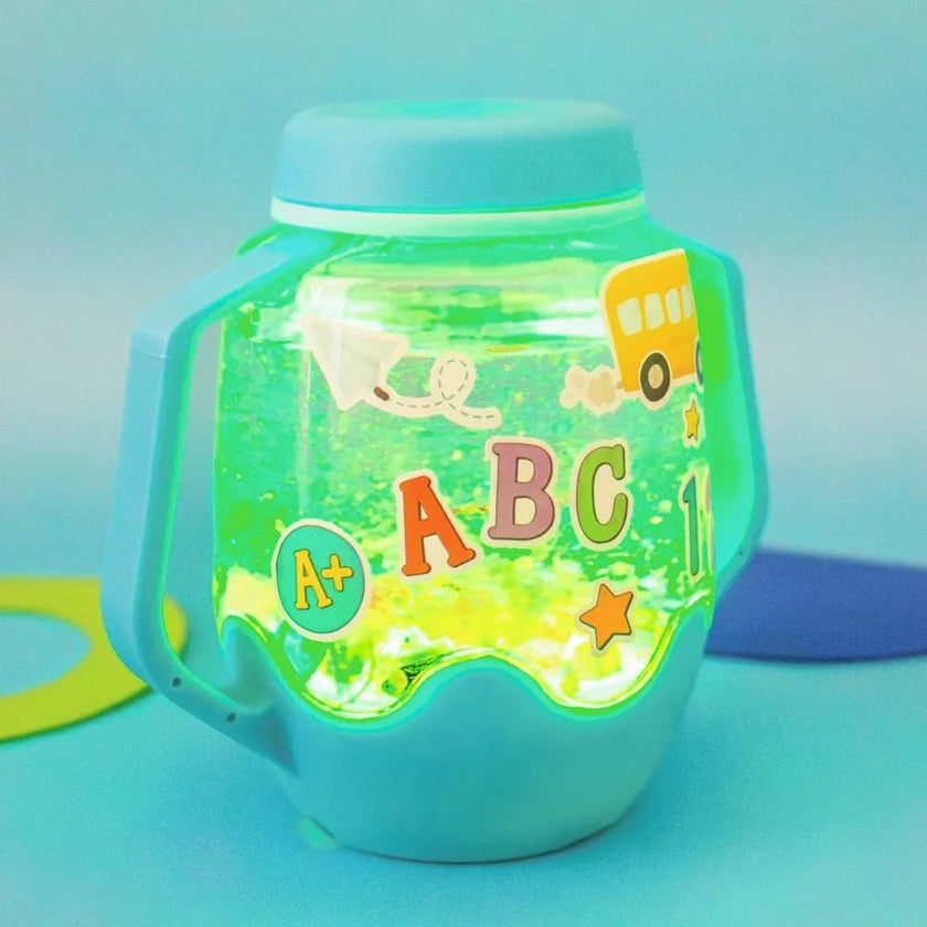 Blue Glo Pals sensory jar glowing green, decorated with ABC letters, numbers and a yellow school bus