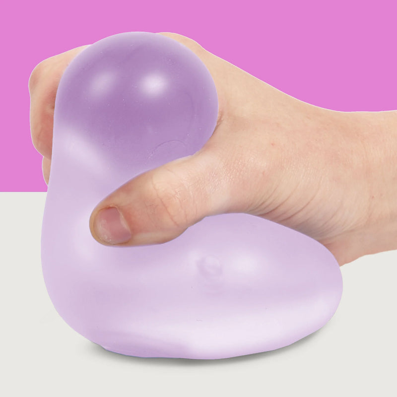 Hand squeezing the lavender Speks Gump Jumbo Mist stress ball

