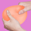 Hands squeezing the orange Speks Gump Jumbo Reef stress ball
