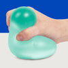 Hand squeezing the teal Speks Gump Jumbo Sea Glass stress ball
