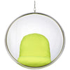 A modern hanging bubble chair with a clear glass or acrylic sphere, a silver metal frame, and a bright lime green cushioned seat and backrest, suspended by a chain against a white background.