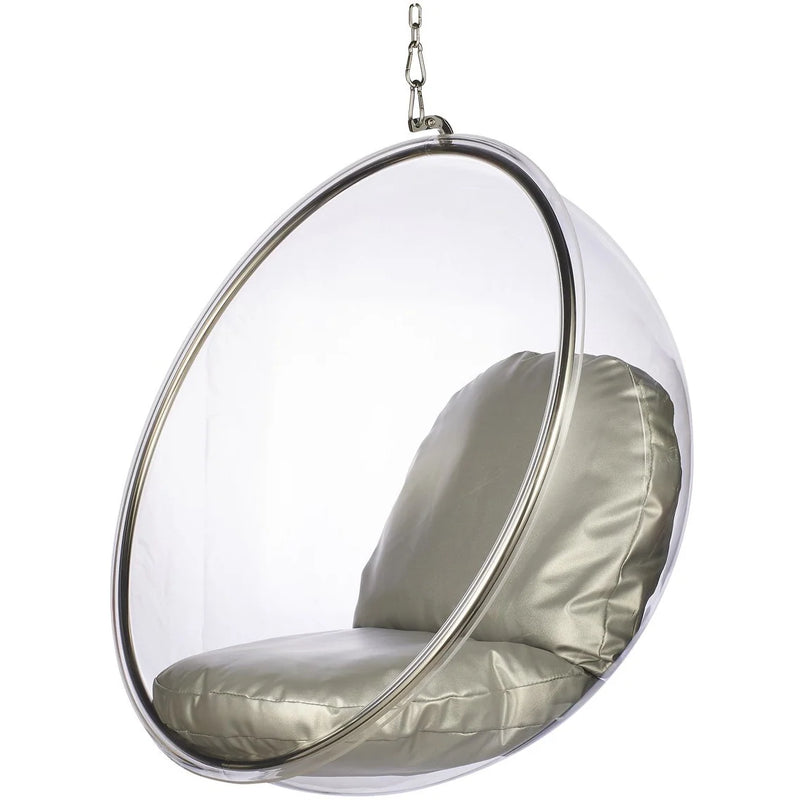 A modern hanging egg chair with a clear transparent plastic or acrylic dome, a silver metal frame, and a padded seat and back cushion in a light champagne or pale gold fabric, suspended by a chain against a plain white background.