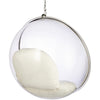 A modern hanging egg chair with a clear transparent spherical shell, a polished silver metal frame, and a cream-colored cushion inside, suspended by a chain against a plain white background.