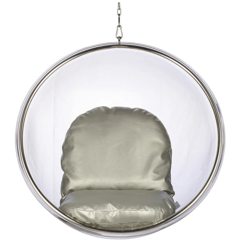 A modern hanging bubble chair with a clear acrylic dome, a polished silver metal frame, and a padded seat cushion in a champagne-gold fabric, suspended by a chain against a plain white background.