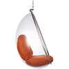 A modern hanging egg chair with a clear transparent plastic shell, a brown upholstered seat cushion, and a chrome metal frame, suspended by a chain against a white background.