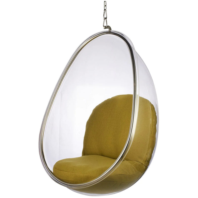 A modern teardrop-shaped hanging egg chair with a clear transparent shell, a silver metal frame, and mustard yellow fabric cushions, suspended by a chain against a white background.