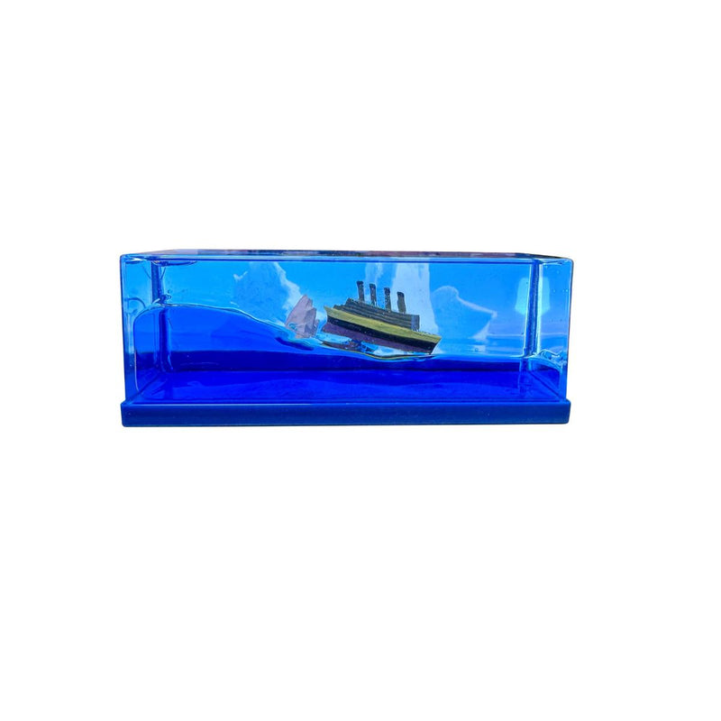 Light Up Ship Liquid Timer with miniature ship tilted beside the iceberg