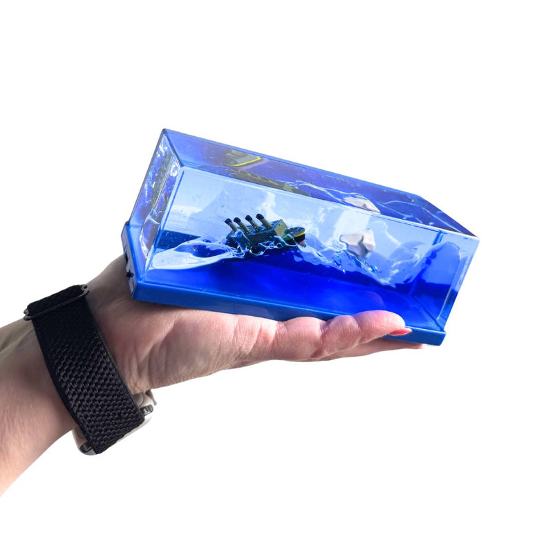 Light Up Ship Liquid Timer resting on an open palm with blue liquid forming a wave