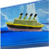 Close-up of the miniature four-funnel ship floating in the Light Up Ship Liquid Timer