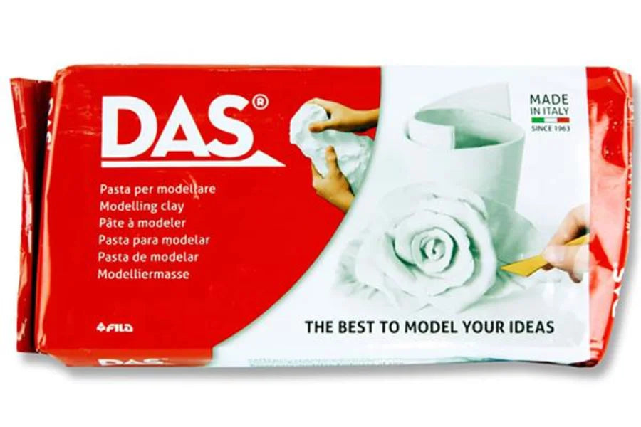 A bar of DAS modelling clay in its original red and white packaging, featuring the brand name 'DAS' and a photo of a sculpted white rose.