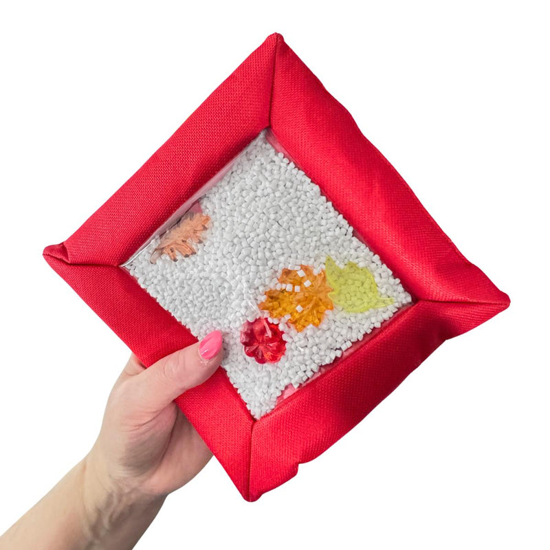 Red Sensory Touch and Search Bag held in one hand with hidden shapes visible