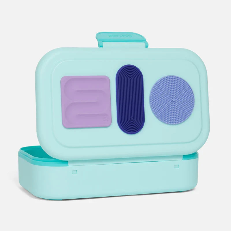 Speks Slabs sensory stickers in three shapes attached to a lunchbox lid

