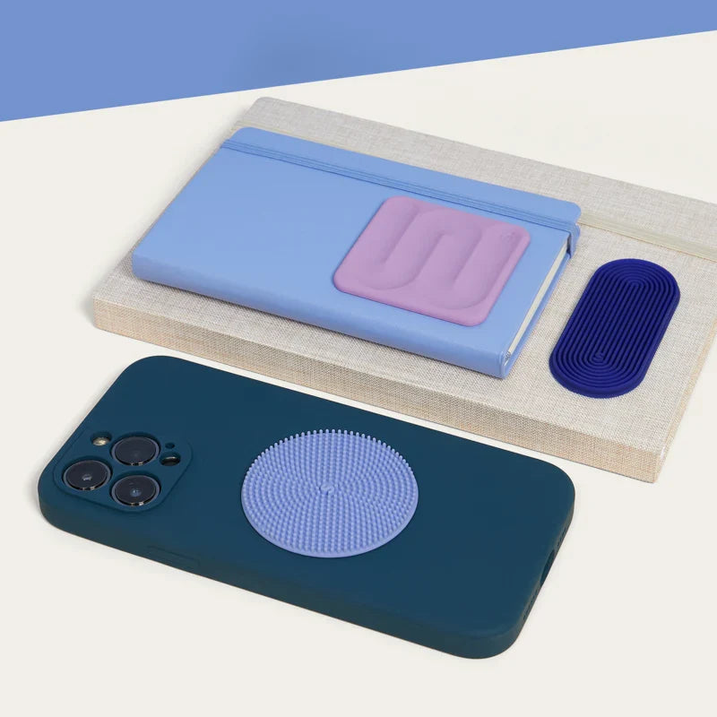 Speks Slabs sensory stickers on a notebook and phone case, showing the square, oval and circle shapes
