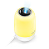 A yellow Vtech portable projector lamp with a white base, shown on a clean white background with a blue light beam projected from the top.
