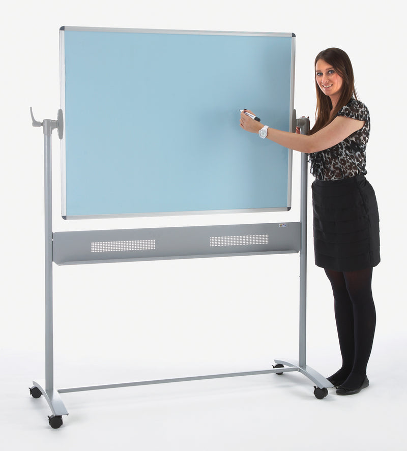 Woman writing on a standing dual-sided whiteboard with a light blue writing surface.