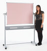 Woman standing next to a large portable whiteboard with a pink colour on a white background