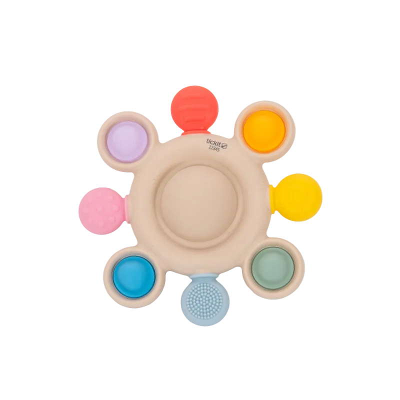 Colorful baby teething ring with various textures on a white background